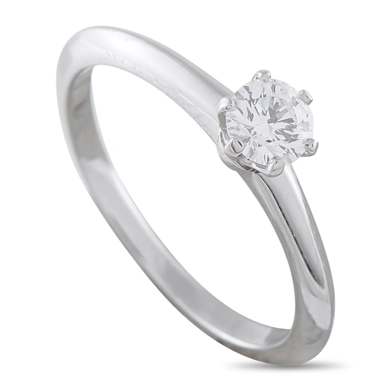 TIFFANY & CO. PLATINUM 0.29CT DIAMOND SOLITAIRE EN: A 0.29 carat Round Brilliant Diamond with F color and VS2 clarity makes a statement at the center of this Tiffany & Co. solitaire engagement ring. Ideal for anyone with a minimalist aesthetic, the Pla