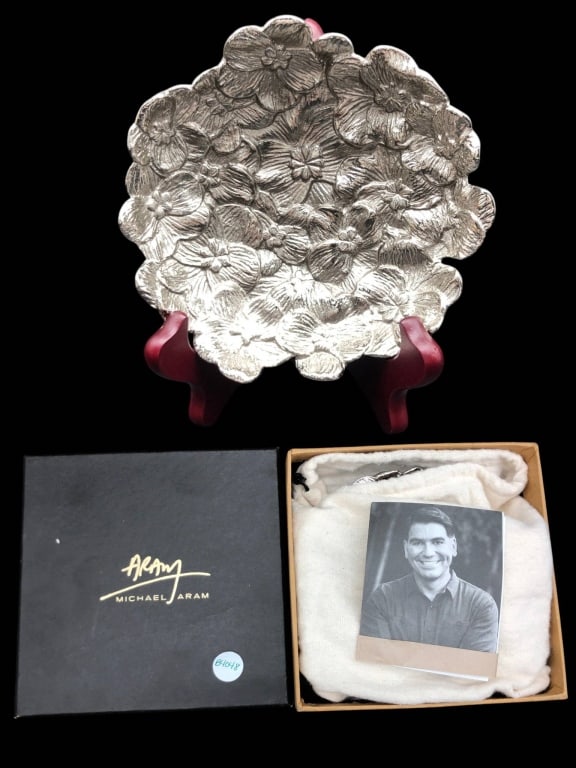 MICHAEL ARAM SILVER TONE FLORAL DISH 5": Michael Aram decorative dish in a silver tone, featuring a floral motif. Approximately 5 inches in height. Includes original box and protective pouch, as well as artist booklet. Excellent display or g