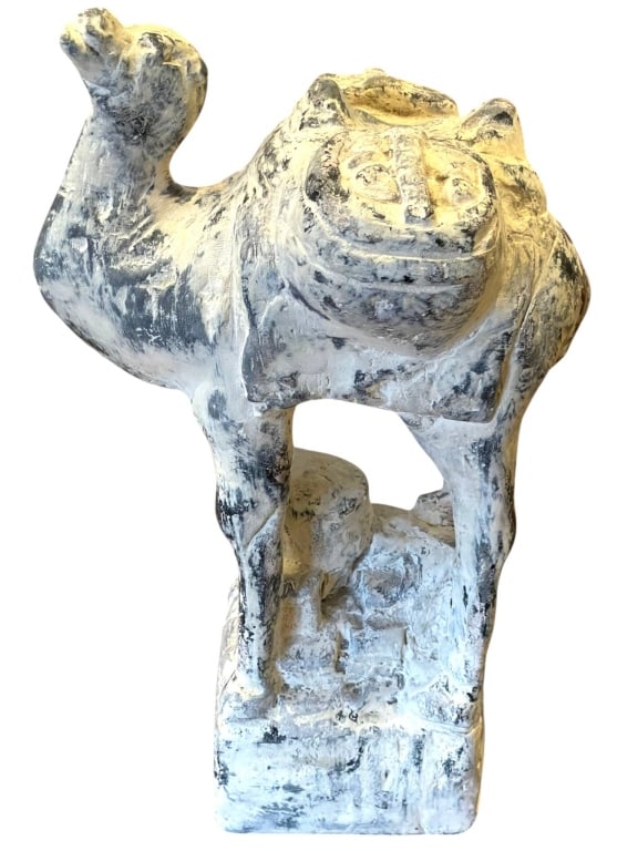 ARABIAN CAMEL SCULPTURE 10.5": Painted ceramic statue of an Arabian camel, standing approximately 10.5" tall and 5" wide at the base. Features detailed saddlebags and an aged surface patina. This decorative piece is ideal for colle