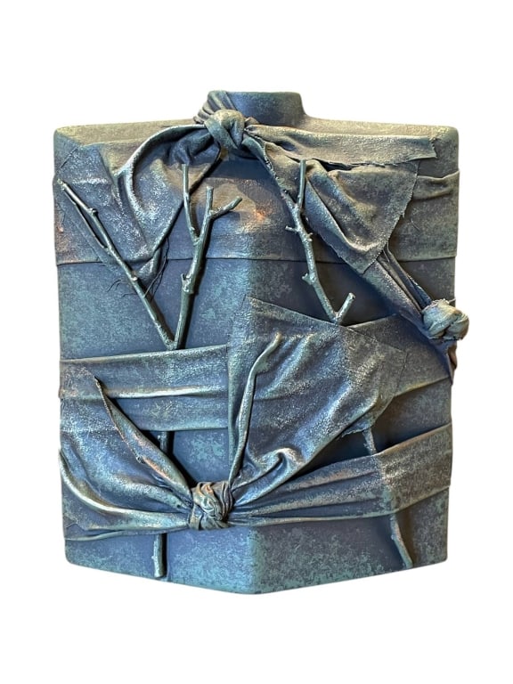 SCULPTURAL VASE WITH WRAPPED RIBBON DESIGN 9": Contemporary sculptural vase featuring an abstract square-form body with hand-built slab construction, raised wrapped ribbon-style relief, twig-form appliqu? details, and a blue-green patinated glaze 