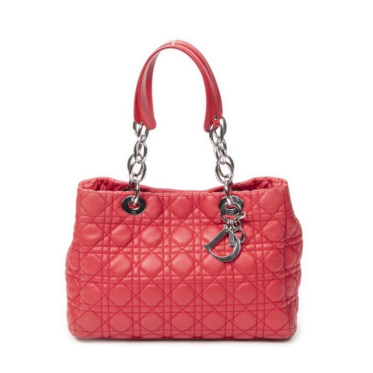 DIOR SOFT RED CANNAGE LAMBSKIN LEATHER BAG: The Dior Small Soft Shopping Tote is crafted in luxurious red Cannage lambskin leather and accented with elegant silver-tone hardware. Featuring the iconic Cannage quilted pattern and a spacious yet r