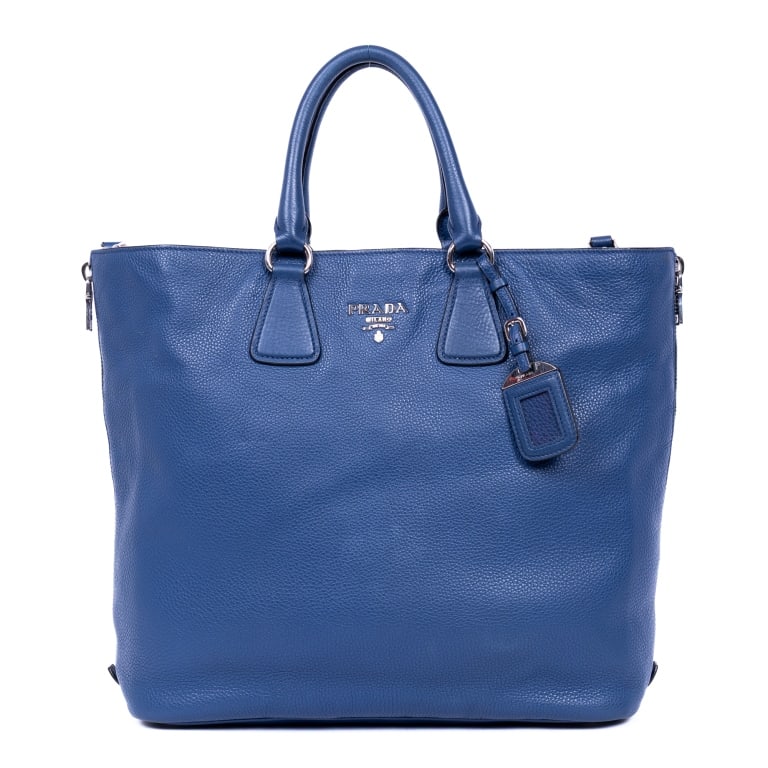 PRADA CLASSIC VITELLO DAINO LEATHER HANDBAG: The Prada Classic Shopping Tote is crafted in rich Bluette Vitello Daino leather with sleek silver-tone hardware for a refined and timeless aesthetic. Its spacious silhouette, supple grained leather, 