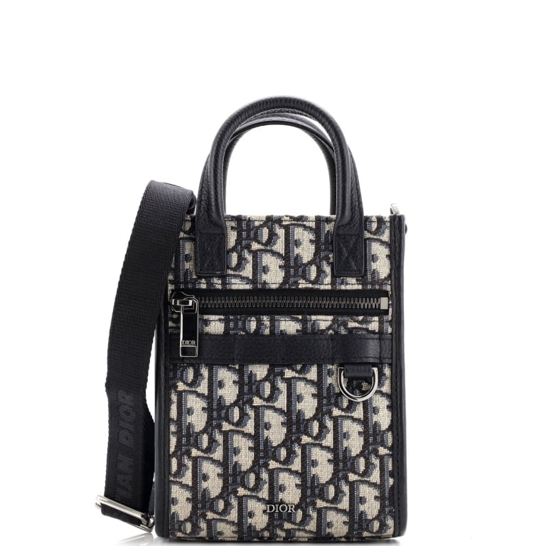 DIOR SAFARI NORTH SOUTH CONVERTIBLE MINI OBLIQUE G: The Dior Safari North South Convertible Tote Mini is crafted in iconic blue Diorissimo Oblique canvas with sleek silver-tone hardware for a modern utilitarian aesthetic. Compact yet functional, this v