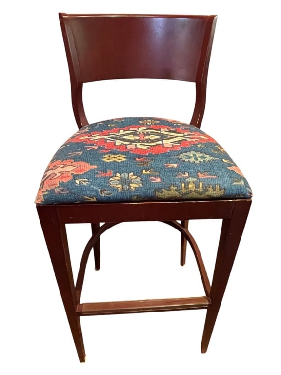 BARSTOOL WITH KILIM UPHOLSTERY 42": This barstool features a wooden frame with a colorful kilim-patterned upholstered seat. The backrest is slightly curved for comfort. Seat and upholstery show minor wear consistent with age, but overal