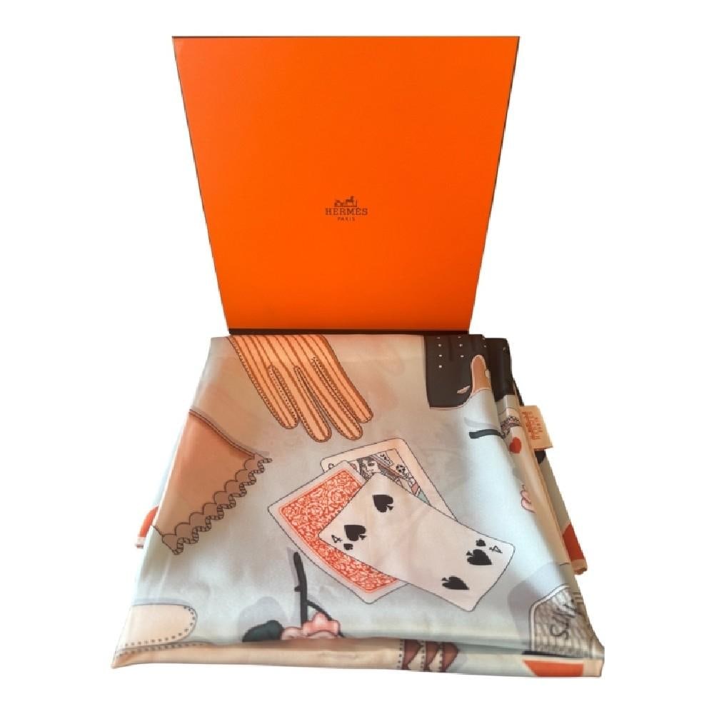 HERMES "GANTS ET GANTERIE" SILK SCARF W/BOX: Elegant Hermes Paris silk scarf featuring the celebrated “Gants et Ganterie” motif designed by renowned American artist Kermit Oliver. This sophisticated composition showcases an arrangement o