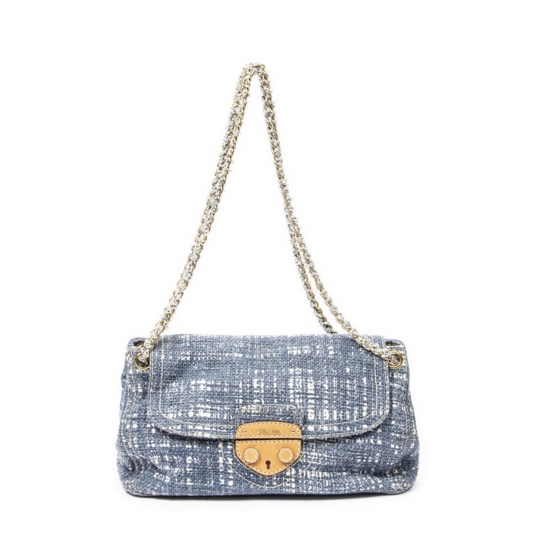 PRADA PUSH LOCK CHAIN BLUE TWEED CANVAS BAG: The Prada Medium Push Lock Chain Flap is crafted in elegant blue tweed canvas and accented with refined hardware details. Featuring a sophisticated chain shoulder strap and signature push-lock