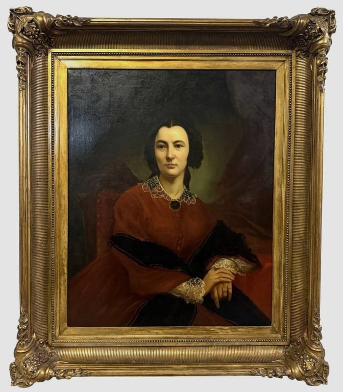 19TH C. AMERICAN SCHOOL PORTRAIT OIL PAINTING 35": Antique American School portrait oil painting on canvas depicting a seated woman in a red dress with lace accents. Circa: Mid-to-late 19th-century. Presented in an ornate hand-carved gilt wood frame w