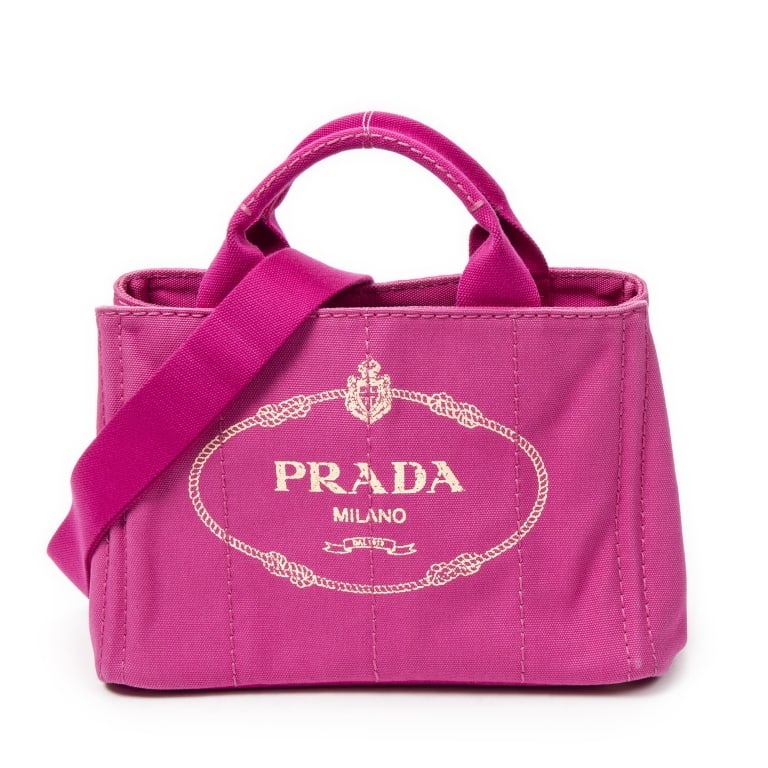 PRADA CANAPA TOTE FUCHSIA PINK CANVAS BAG: The Prada Small Canapa Tote is crafted in vibrant fuchsia pink Canapa canvas and accented with elegant gold-tone hardware. Featuring Prada's iconic structured tote silhouette, this stylish and versati