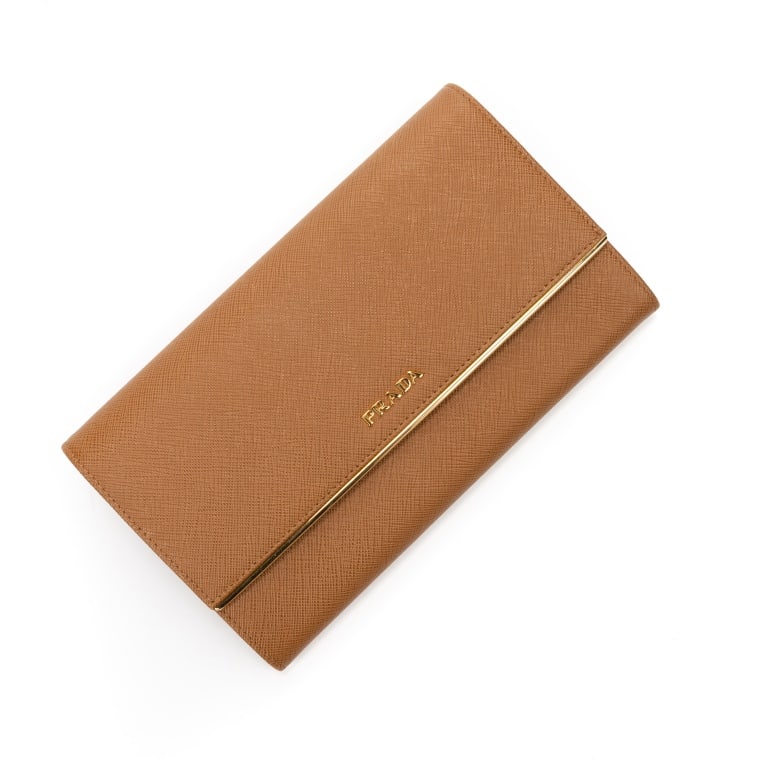 PRADA CARAMEL SAFFIANO CONTINENTAL WALLET BAG: The Prada Continental Flap Wallet is crafted in luxurious caramel Saffiano leather, showcasing the house's iconic crosshatch texture and timeless elegance. Designed with a sleek flap silhouette, this 