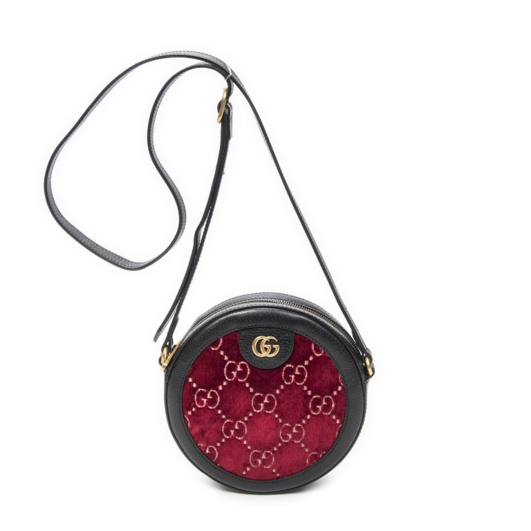 GUCCI OPHIDIA ROUND MINI RED BLACK BAG: The Gucci Mini Ophidia Round Crossbody is crafted in striking red and black monogrammed velvet canvas and accented with elegant gold-tone hardware. Featuring the iconic Ophidia collection styling and 