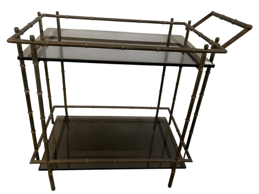 BAMBOO STYLE BAR CART SMOKEY GLASS 32": Bar cart featuring a metal bamboo-style frame and two smokey glass shelves. Includes a handle on one side for easy maneuverability. Suitable for serving and display purposes. | | Measures