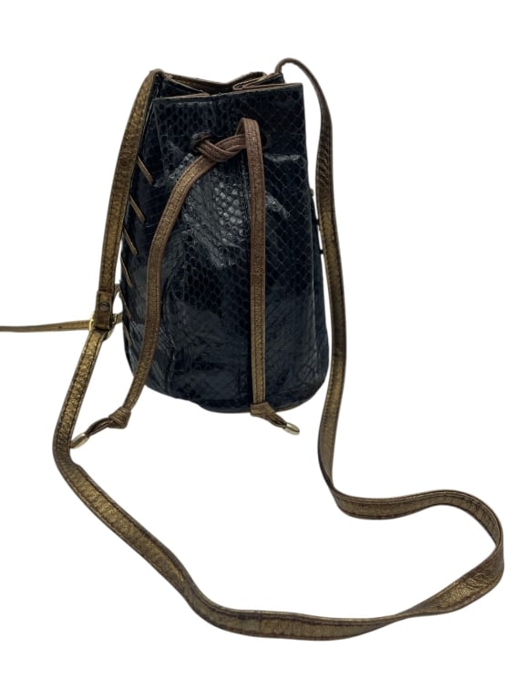 8" EELSKIN BLACK MOE STYLE TIE TOP XBODY BAG: Vintage eelskin drawstring bucket bag, likely 1980s?1990s. Crafted from genuine eel skin, known for its distinctive narrow, glossy scale pattern and soft, flexible feel. The bag features a classic buc