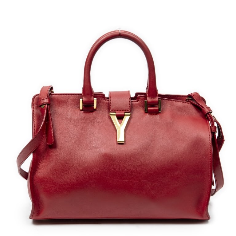 YSL CLASSIC Y CABAS SMALL RED BAG: The Yves Saint Laurent Small Classic Y Cabas is crafted in luxurious red calfskin leather and accented with elegant gold-tone hardware. Featuring the iconic Y-front design that defined an era of