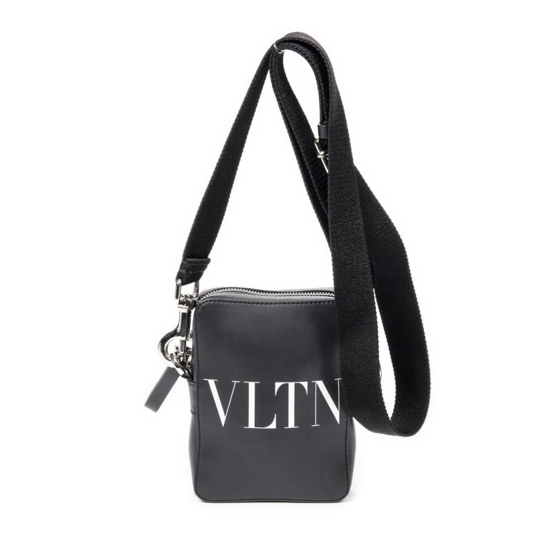 VALENTINO VLTN MINI WHITE BLACK CROSSBODY BAG: The Valentino VLTN Mini Crossbody is crafted in striking white and black VLTN Times leather, showcasing the bold contemporary aesthetic that has become synonymous with the house. Compact yet stylish,