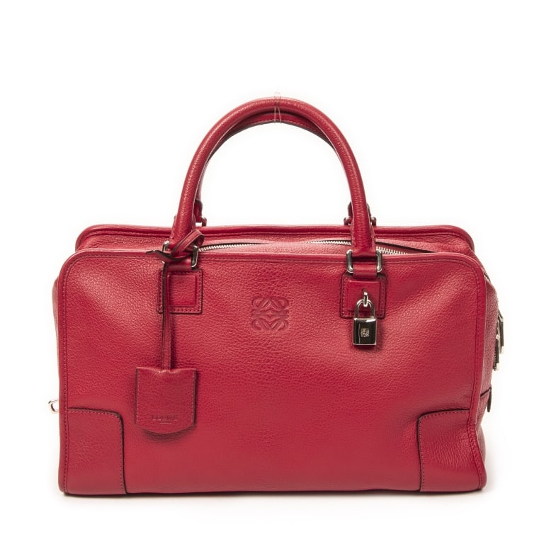 LOEWE AMAZONA 36 FUCHSIA GOATSKIN LEATHER BAG: The Loewe Amazona 36 is an iconic luxury handbag crafted in vibrant fuchsia goatskin leather and accented with sleek silver-tone hardware. Celebrated for its structured silhouette and exceptional Span