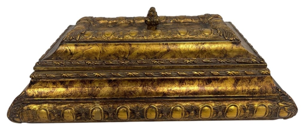 GILDED RECTANGULAR DECORATIVE STORAGE BOX 16": Rectangular decorative box with gilded finish and ornate pattern. Features a stepped design and domed edges with repeating oval motif on the sides. Central decorative knob on the lid. | | Measures app