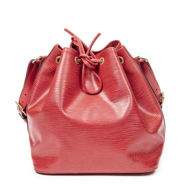 LOUIS VUITTON NOE PM RED EPI BAG: The Louis Vuitton Noe PM is a timeless bucket bag crafted in vibrant red Epi leather, showcasing the house's signature textured finish and exceptional craftsmanship. Originally designed to carry