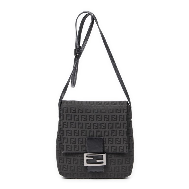 FENDI SMALL ZUCCHINO FLAP CROSSBODY BAG: The Fendi Small Flap Crossbody is crafted in classic black Zucchino canvas, showcasing one of the house's most recognizable archival patterns. Featuring a sleek flap-front silhouette and lightweight c