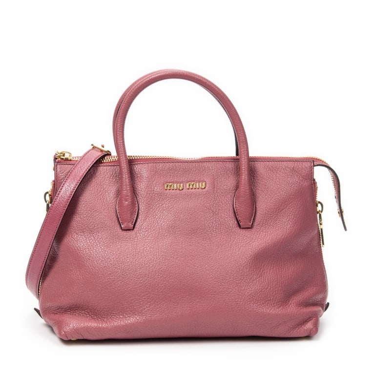 MIU MIU SIDE ZIP TOTE PINK GOATSKIN SHOULDER BAG: The Miu Miu Side Zip Convertible Tote is crafted in luxurious pink goatskin leather and accented with elegant gold-tone hardware. Featuring distinctive side zip expansions and a versatile convertible 