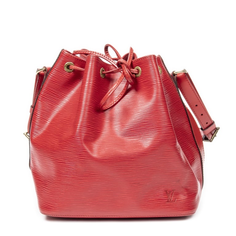 LOUIS VUITTON NOE PM RED EPI BAG: The Louis Vuitton Noe PM is a timeless bucket bag crafted in vibrant red Epi leather, showcasing the house's signature textured finish and enduring craftsmanship. Originally designed to carry champagn