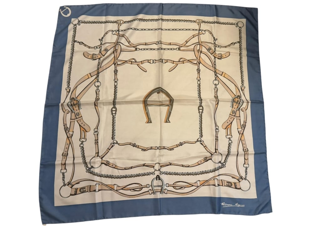 ADRIENNE AIGNER 100% SILK EQUESTRIAN SCARF: Vintage Adrienne Aigner 100% silk scarf featuring a classic equestrian motif with bridles, stirrups, chains, horse tack, and a central horseshoe-style emblem in cream, navy blue, tan, and silver tones