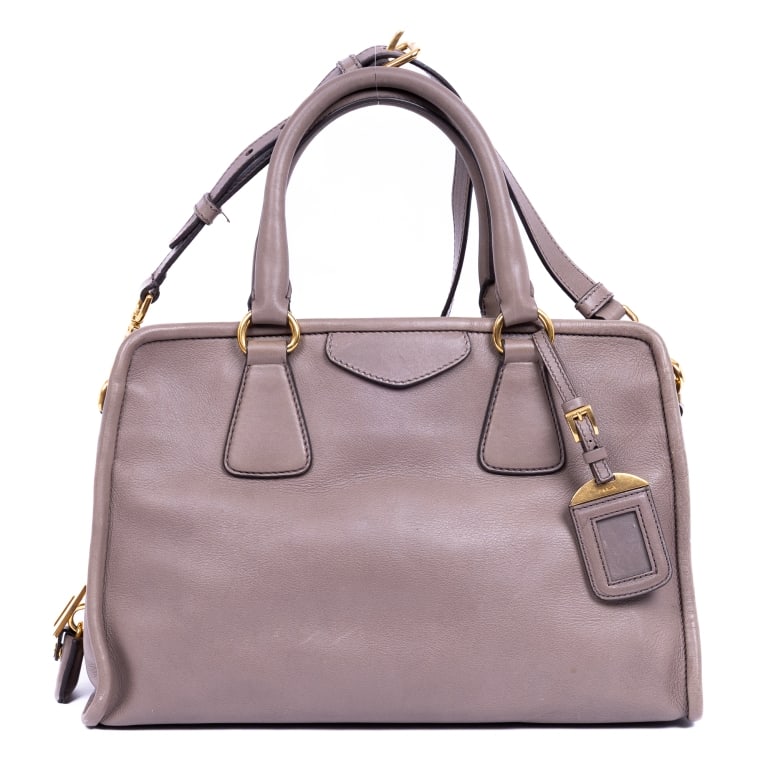 PRADA PINK VITELLO PHENIX CABAS BAG: The Prada Frame Open Crossbody Cabas is crafted in luxurious pink Vitello Phenix leather and accented with elegant gold-tone hardware. Featuring a sophisticated open-frame design and spacious Cabas