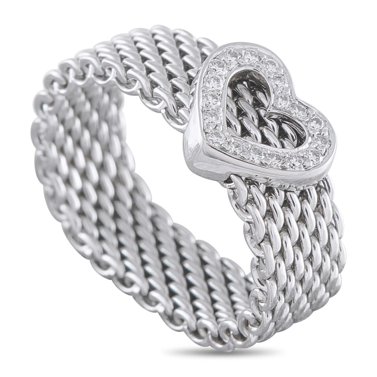 TIFFANY & CO. 18K WHITE GOLD DIAMOND HEART RING TI: This Tiffany & Co. ring is incredibly charming. Crafted from 18K White Gold, the mesh band is perfectly juxtaposed with a heart-shaped motif accented by inset Diamonds. A 6mm wide band and a 4mm top h