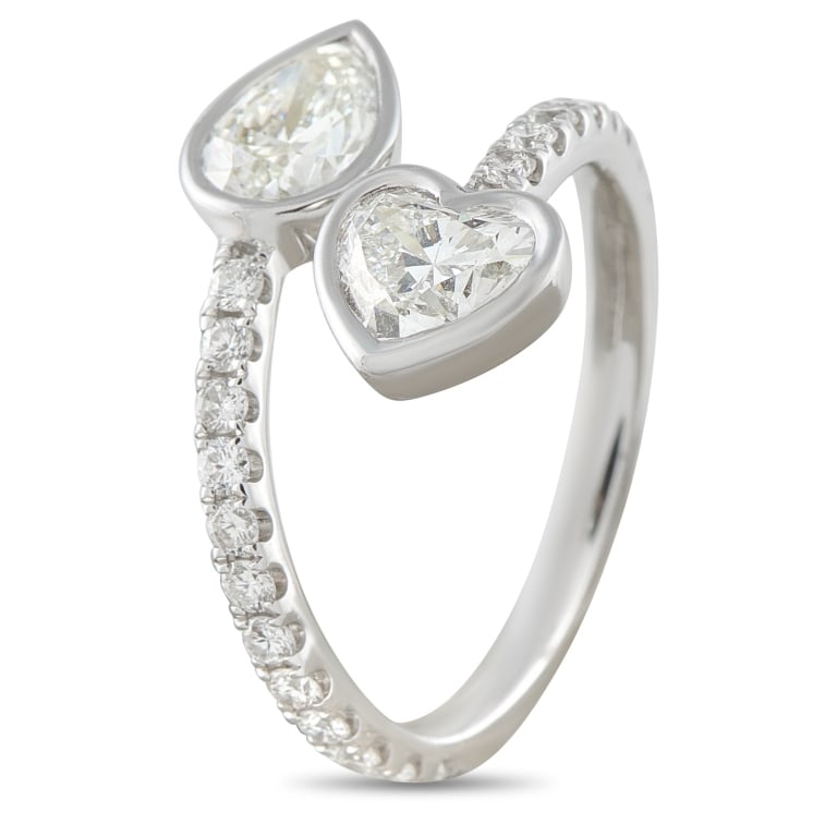 18K WHITE GOLD 1.90CT DIAMOND BYPASS RING ALR-1907: This bypass ring will instantly capture your imagination. Set in 18K White Gold, a pear-shaped Diamond and a heart-shaped Diamond totaling 1.45 carats make a statement at each end of the design. Diamo
