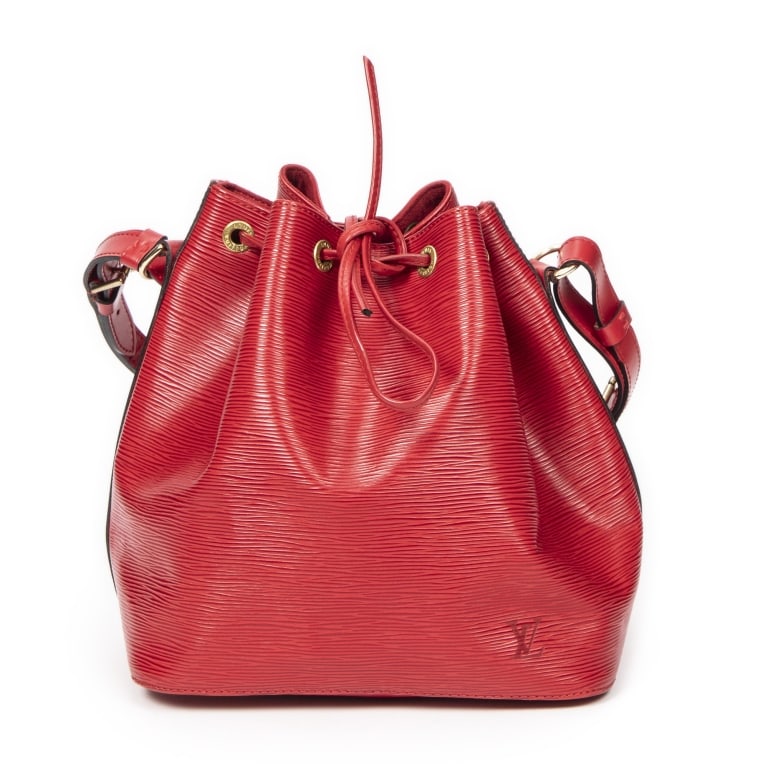 LOUIS VUITTON NOE PM RED EPI BAG: The Louis Vuitton Noe PM is a timeless bucket bag crafted in vibrant red Epi leather, showcasing the maison's signature textured finish and enduring craftsmanship. Originally designed to carry champag