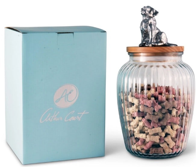 NEW IN BOX ARTHUR COURT DOG TREAT JAR: NEW IN BOX ARTHUR COURT DOG TREAT JARLovely glass jar is topped with an environmentally sustainable Acacia wood lid. Detailed metal art in aluminum, a cute pup waiting for a treat, tops the jar. A pre