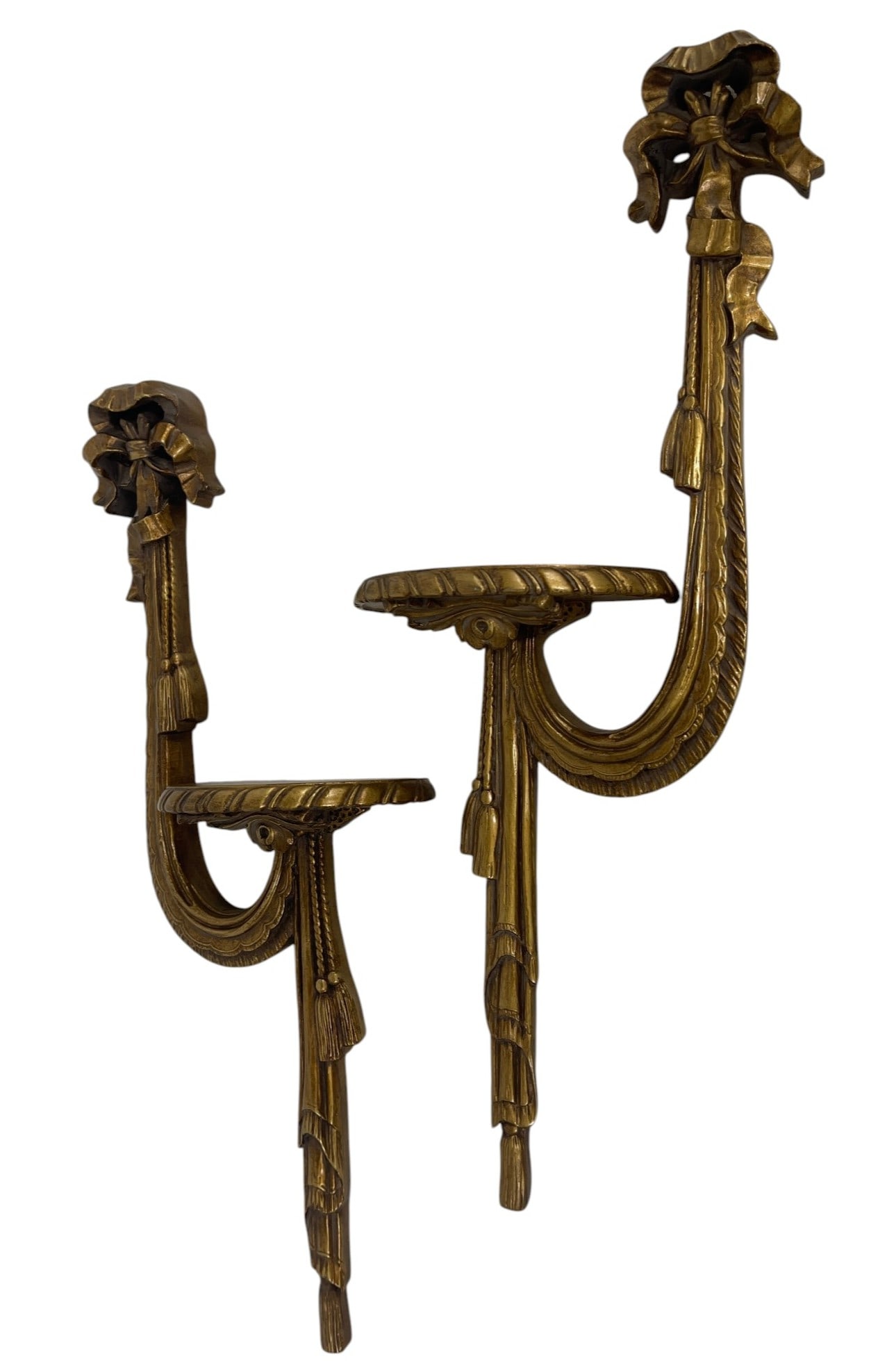 PAIR OF FRENCH STYLE GILTWOOD WALL BRACKETS 23": Elegant pair of French Louis XVI style giltwood wall brackets featuring ribbon bow crests, draped tassel motifs, and fluted decorative carvings. Each wall-mounted bracket is finely detailed with a cur