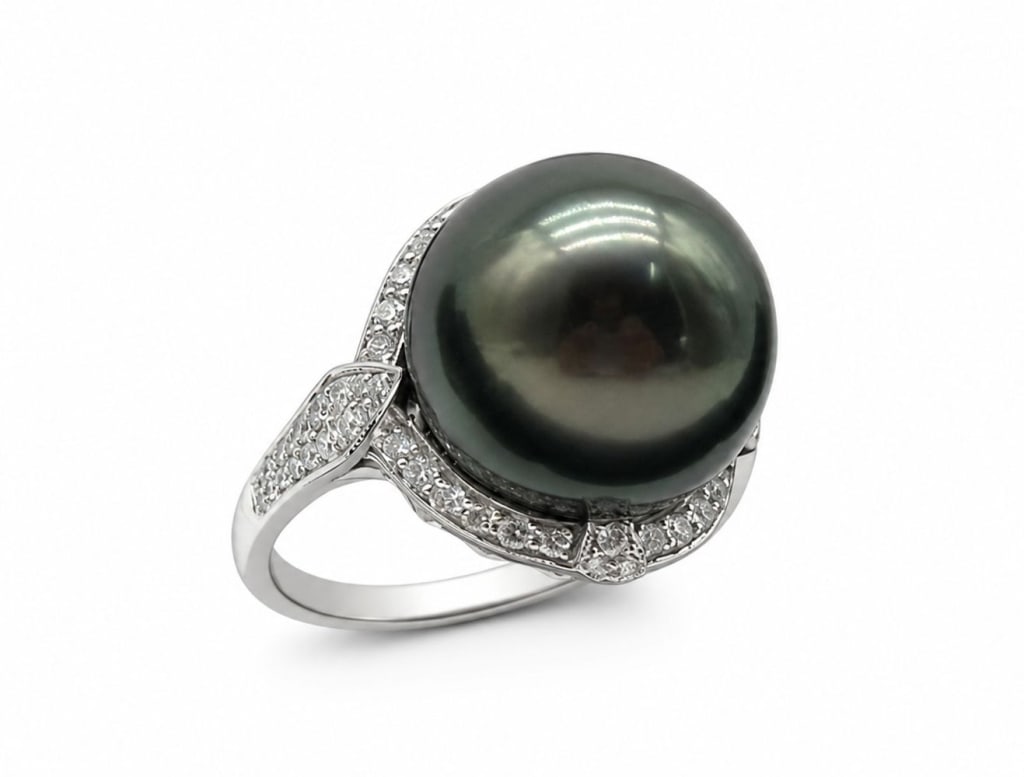 GIA TAHITIAN PEARL & DIAMOND PLATINUM RING: Platinum ring featuring a GIA certified South Sea Tahitian cultured pearl measuring 14.14 mm with dark gray body color and orient overtone. The mounting is accented with approximately 0.48 carats tota