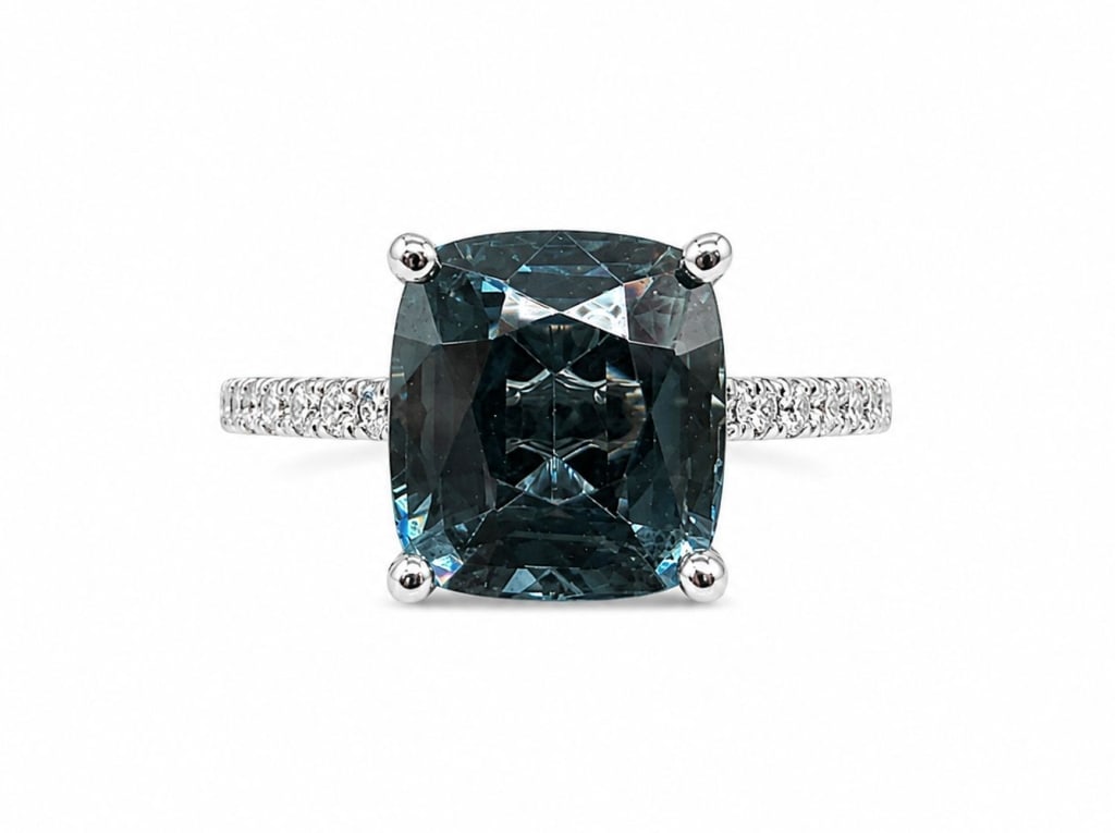 GIA 18K WHITE GOLD 2CT BLUE SPINEL & DIAMOND RING: 18 karat white gold ring featuring a GIA-certified natural blue spinel weighing 2.01 carats in a cushion cut. The center stone is accented by 14 round brilliant-cut diamonds with a total weight of