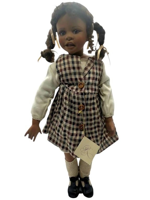 KAYE WIGGS LIMITED EDITION DOLL "CATHERINE" 23": Signed Kaye Wiggs “Catherine” collectible doll, circa 1997, numbered 399/2500, featuring expressive painted facial details, curly pigtails with ribbon ties, plaid jumper dress, cream blouse,