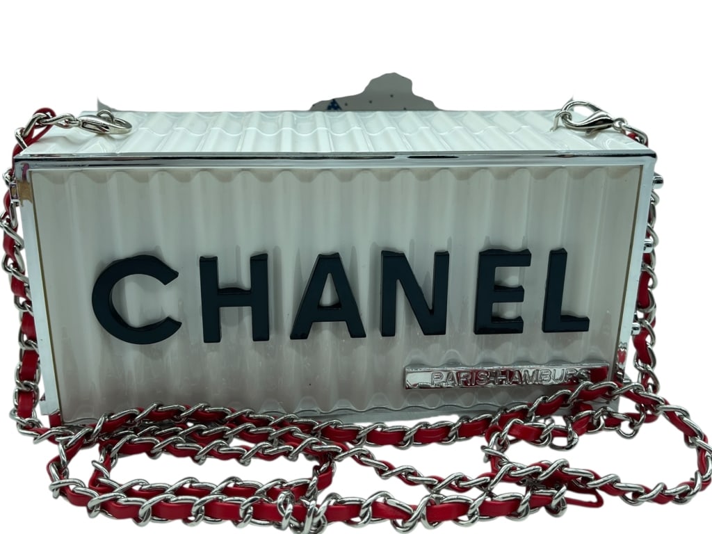 CHANEL PARIS-HAMBURG WHITE ACRYLIC BOX HANDBAG: Make a bold statement with this striking CHANEL PARIS-HAMBURG Acrylic Box Chain Shoulder Bag. Featuring a sophisticated white acrylic box silhouette accented by bold black CHANEL lettering, this eye-c