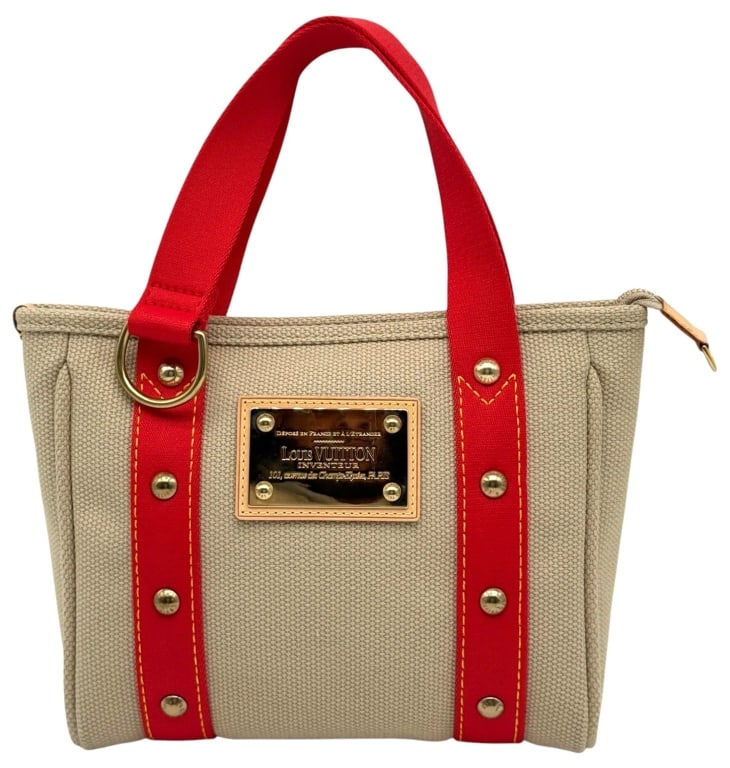 LOUIS VUITTON ANTIGUA CABAS PM CANVAS TOTE: Louis Vuitton Antigua Cabas PM tote bag in beige canvas with red canvas handles and trim, accented by gold-tone hardware and the signature front plaque. Features a zip-top closure, striped red textile