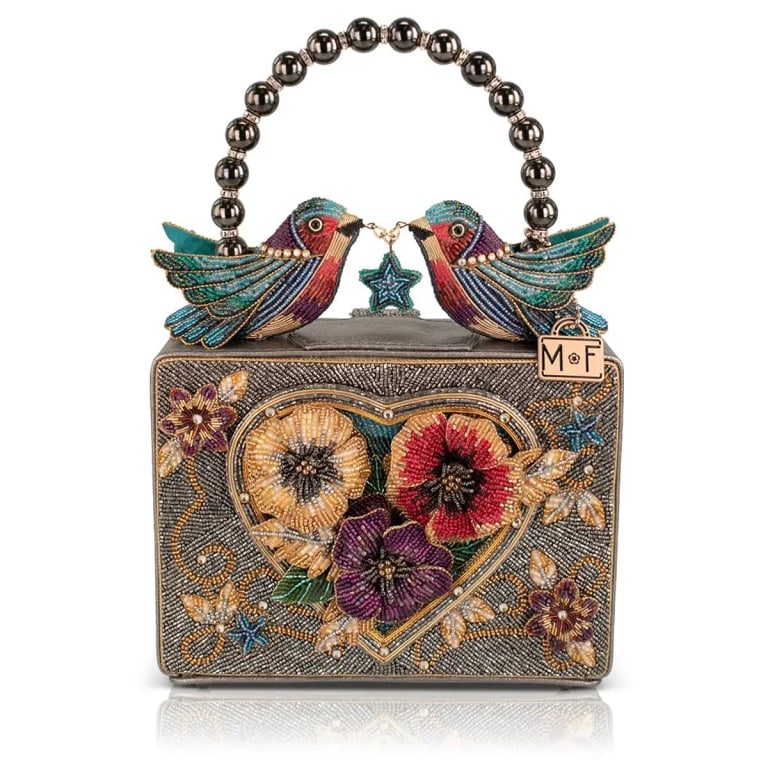 NEW MARY FRANCES FLUTTERING HEART BAG: This purse didn't come here to blend in. Dripping in hand-beaded bronze shimmer with two lovebird hummingbirds perched on top like they own the place, it's the kind of accessory that turns a Tuesday i