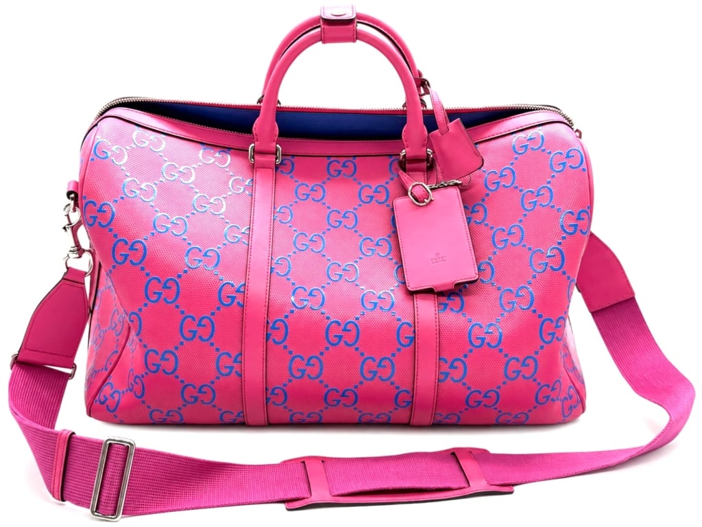 GUCCI PINK GG PERFORATED DUFFEL BAG: Combining Gucci's iconic heritage branding with a contemporary color palette, this bold and spacious travel bag offers a striking and highly collectible design that is instantly recognizable. Silver-t