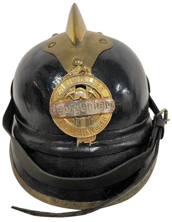 ANTIQUE GERMAN FREIWILLIGE FEUERWEHR HELMET 10": This antique German volunteer fire brigade helmet features a black lacquered leather body with brass trim, prominent spike finial, and original front badge reading "Freiwillige Feuerwehr Georgenberg."