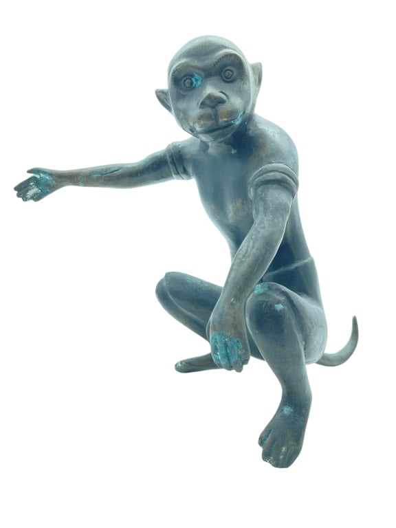 BRONZE MONKEY FIGURAL SCULPTURE 11.5": BRONZE MONKEY FIGURAL SCULPTURE 11.5"-A whimsical and expressive bronze monkey sculpture depicted in a crouching pose with one arm extended forward. The figure features exaggerated facial characterist