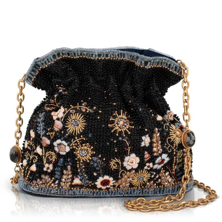 NEW! MARY FRANCES LE JARDIN BAG: A secret garden you can carry on your arm. Le Jardin is a hand beaded bucket bag blooming with delicate florals and golden sunbursts scattered across a deep navy backdrop, giving it the feeling of a