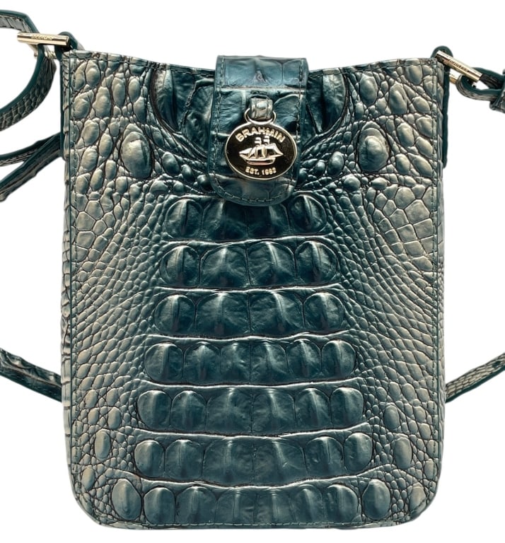 BRAHMIN MELBOURNE EMBOSSED CROSSBODY BAG 8": This stylish Brahmin crossbody bag is crafted in the brand's signature Melbourne embossed leather with a striking teal-blue metallic finish and crocodile-embossed texture. The compact silhouette featu