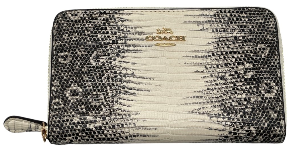 COACH LIZARD PRINT ZIP WALLET 7": This Coach zip-around wallet features an eye-catching lizard-inspired print in shades of black, gray, and ivory with gold-tone Coach New York hardware. The sleek continental-style design offers a full