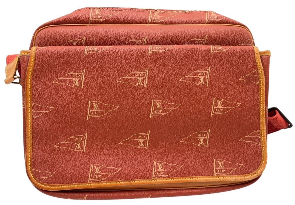 LOUIS VUITTON CUP MESSENGER BAG 15": This Louis Vuitton Cup for The America's Cup messenger bag features the distinctive LV Cup regatta-inspired flag motif printed across a rich red coated canvas exterior with natural vachetta leather tr