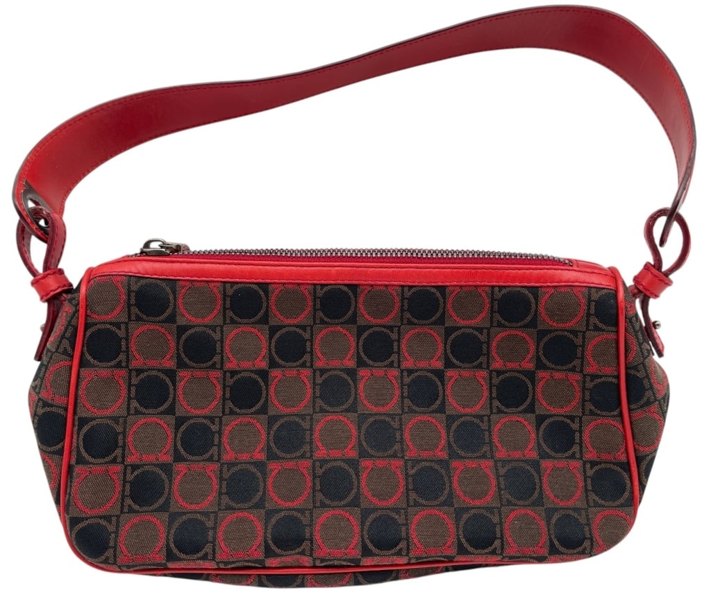 SALVATORE FERRAGAMO GANCINI BAG 10?: This Salvatore Ferragamo shoulder bag features the iconic Gancini monogram canvas in rich brown and red tones accented by vibrant red leather trim and matching shoulder strap. The compact silhouette i