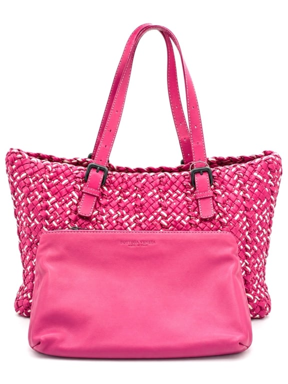 BOTTEGA VENETA PINK INTRECCIATO TOTE W POUCH 12": This striking Bottega Veneta tote showcases the house's renowned Intrecciato craftsmanship in vibrant pink woven leather with contrasting cream leather accents woven throughout the design. Crafted in