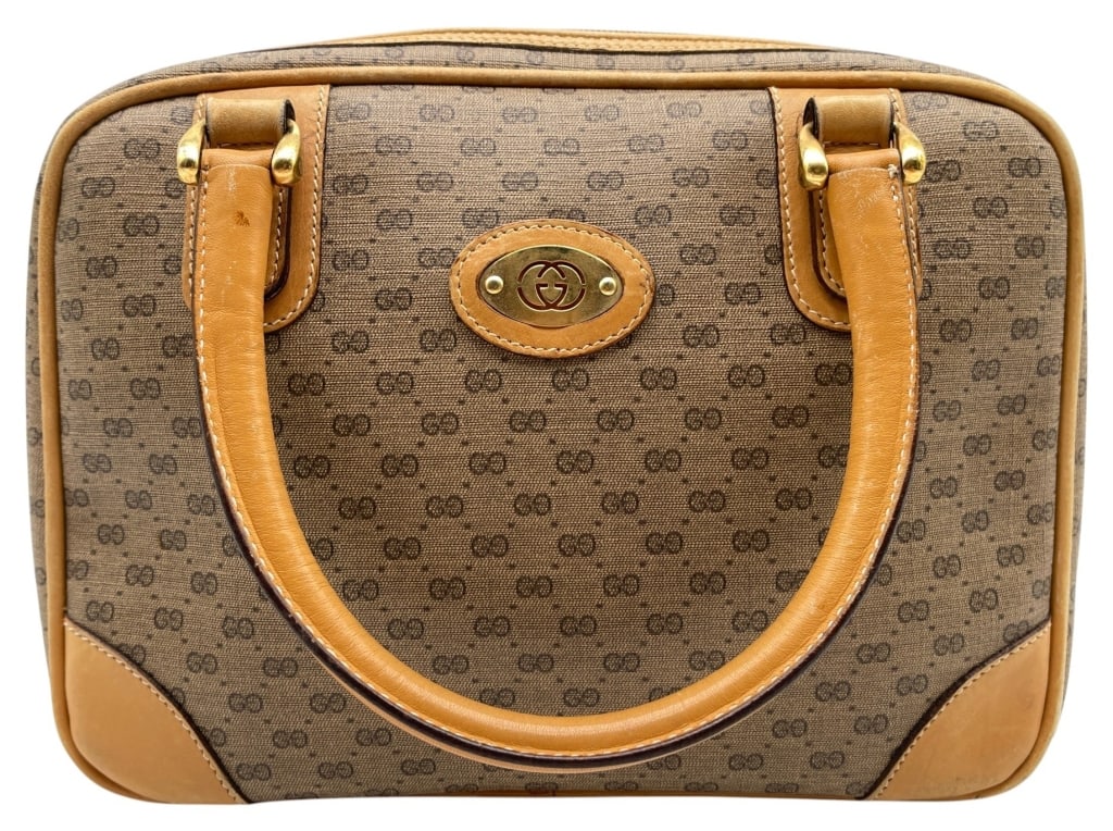 VINTAGE GUCCI MONOGRAM SATCHEL 10?: This vintage Gucci satchel features the iconic GG monogram canvas in a classic beige and brown colorway accented with tan leather trim and rolled leather handles. The structured silhouette is highligh