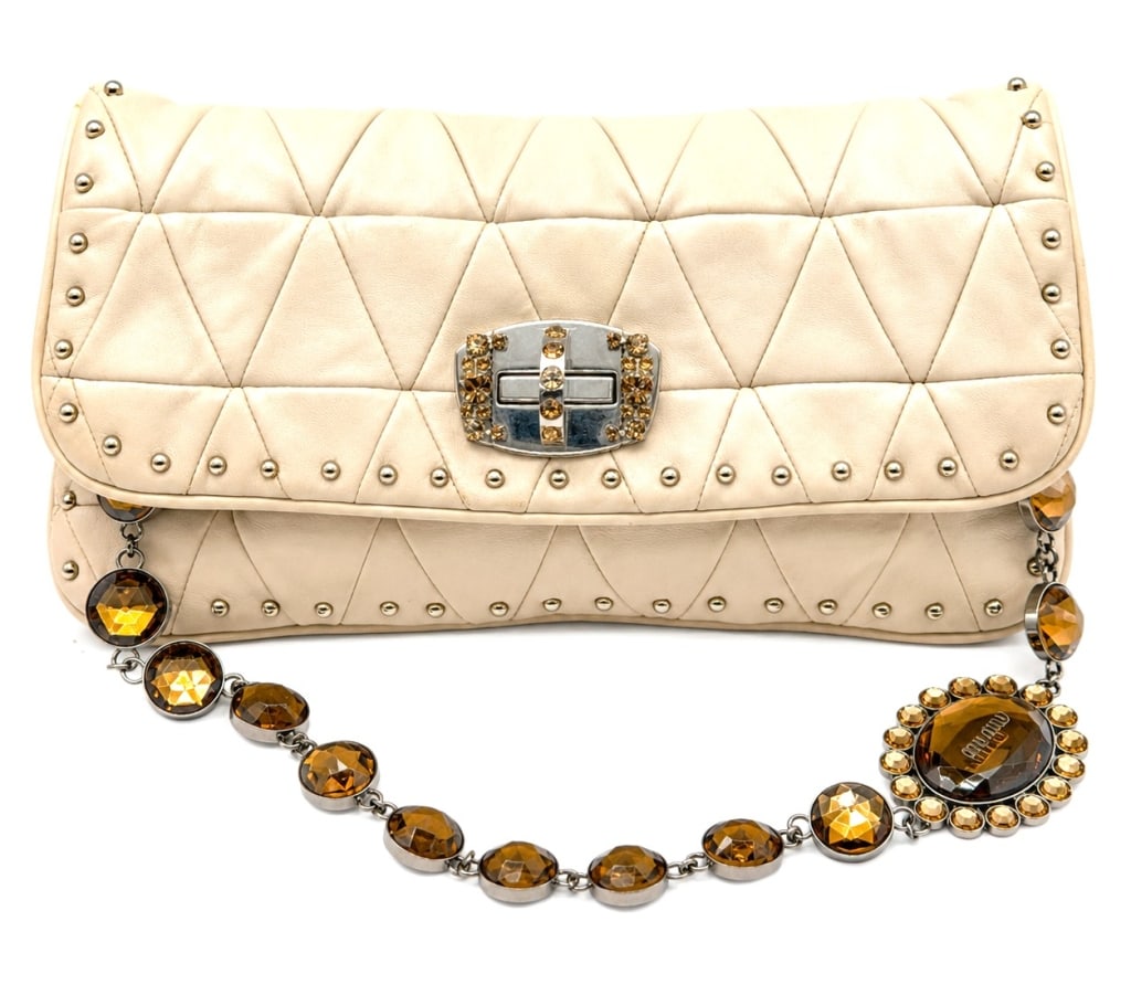 MIU MIU CRISTAL NAPPA POCHETTE BAG 11": This authentic Miu Miu Avorio Nappa Leather Cristal Pochette Bag features supple cream quilted nappa leather with the house?s signature geometric matelass?-inspired pattern, silver-tone stud accents, 