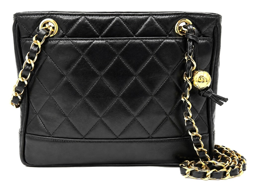 CHANEL QUILTED LAMBSKIN TOTE BAG 10": This vintage Chanel black quilted lambskin tote showcases the timeless elegance that has made Chanel one of the world's most coveted luxury houses. Crafted in supple black lambskin leather with signat