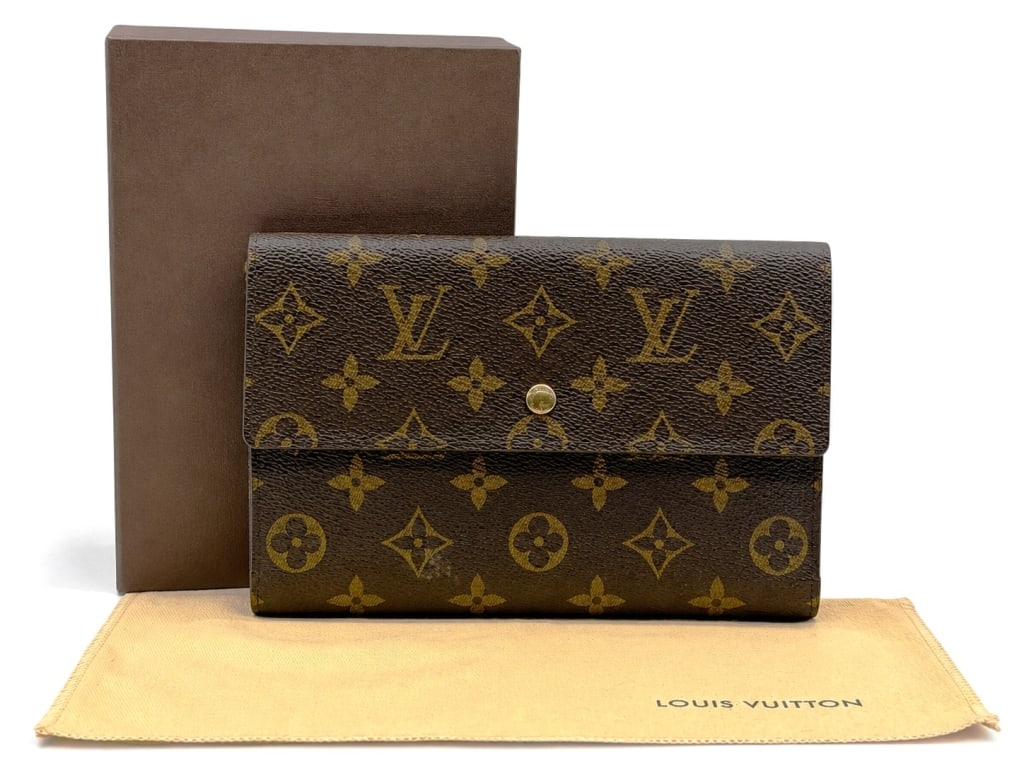 LOUIS VUITTON MONOGRAM TRAVEL ORGANIZER 8": Classic Louis Vuitton vintage travel organizer crafted in the iconic Monogram coated canvas with a structured envelope-style design and snap closure. The interior features multiple card slots, a full-